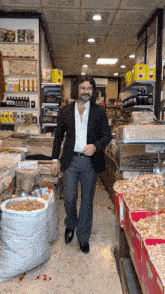 a man in a suit walks through a store filled with food