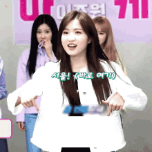 a girl in a white jacket stands in front of a sign that says u