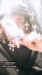 a man holding a cell phone with crosses around him
