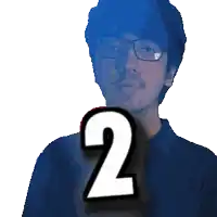 a man wearing glasses is holding up the number 2