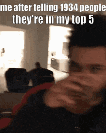 a man drinking from a glass with a caption that reads " me after telling 1934 people they 're in my top 5 "