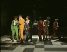 a group of men are standing on a checkerboard floor