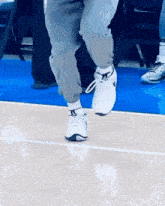 a person wearing a pair of nike shoes is jumping on a basketball court