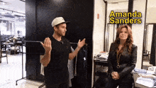 a man and a woman are standing next to each other with a sign that says amanda sanders
