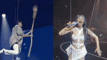 a man holding a broom and a woman singing into a microphone on a stage