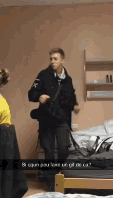 a man is dancing in a room with a caption that says si qqun peu faire un gif de ca?