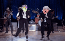 a group of men are dancing on a stage with one wearing a hat that says ' mr ' on it