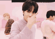 a man in a pink sweater is making a face