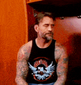 a man wearing a black tank top with an eagle on it