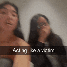 two women are standing next to each other and the caption says acting like a victim