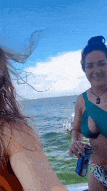 a woman in a bikini is holding a blue can