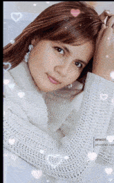 a woman in a white sweater with hearts surrounding her