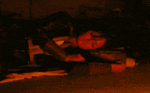 a woman is laying on the ground with her eyes closed and holding a cup