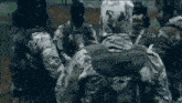 a group of soldiers are standing next to each other .