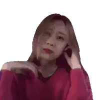 a pixelated image of a woman wearing a red sweater