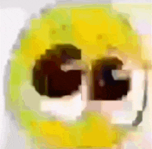 a close up of a yellow smiley face with the letters gg visible