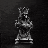a black and white statue of a king with a crown