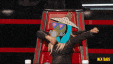 a woman wearing a gas mask and a sombrero sits in a chair with meatbags written on the bottom