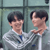 two young men are standing next to each other and one is wearing a name tag that says ' y ' on it