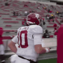 a football player wearing a white jersey with the number 10 on the back