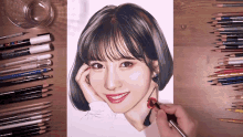 a drawing of a woman 's face is being completed with colored pencils