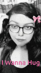 a black and white photo of a girl with glasses and the words i wanna hug on the bottom