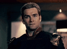 a close up of a man 's face with a slight smirk on his face