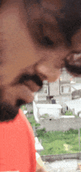 a close up of a man 's face with a beard