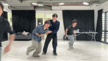 a group of people are dancing in a room with a sign that says no smoking