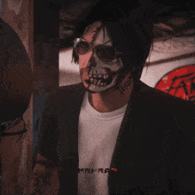a man with a skull on his face and a shirt that says mrkh ap
