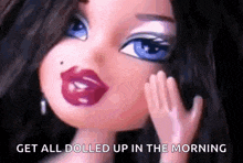a doll with red lips and blue eyes is holding her hand to her face .