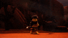 a person is standing in the middle of a desert surrounded by rocks and a glowing object .