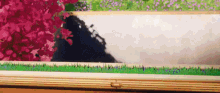 a painting of a landscape with flowers and grass on a wooden table .