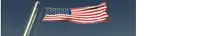 an american flag is waving in the wind