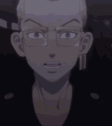 a close up of a man 's face with glasses