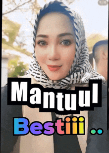 a woman wearing a head scarf with the words " mantul bestii " on the bottom