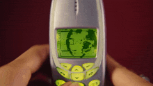 a person is holding a cell phone with a green screen that says ' lg ' on it