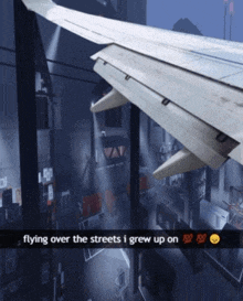 a picture of an airplane wing with the caption flying over the streets i grew up on ..