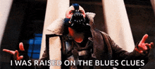 a man wearing a mask is standing in front of a building and says i was raised on the blues clues .