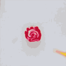 a yellow pencil has a red rose on it