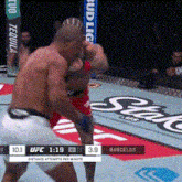 two men are fighting in a boxing ring with a bud light banner