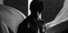 a black and white photo of a man without a shirt on