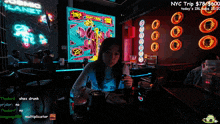 a woman is sitting at a table in front of a neon sign that says cosmic planet