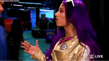 a woman with purple hair is standing in front of a sign that says wwe live