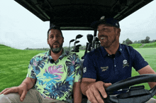 a man wearing a blue reebok shirt is driving a golf cart