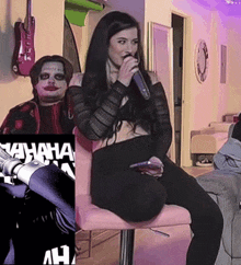 a woman is sitting in a chair with a microphone in her mouth while a man in a joker costume looks on