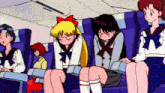 a group of anime girls are sitting on a plane with one girl sleeping