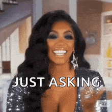 a woman is smiling and saying just asking