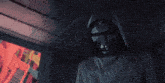 a man stands in a room with game over written on the wall