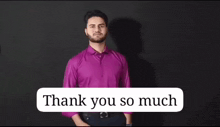 a man in a purple shirt is saying thank you so much in sign language .